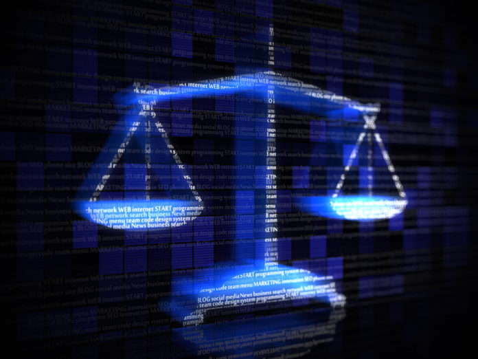 Blue scales with computer coding terms Legal tech: pros v cons
